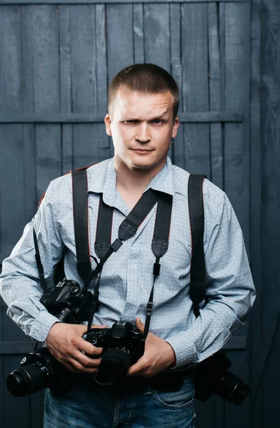 Photographer man with journalist cameras — Stock Photo, Image