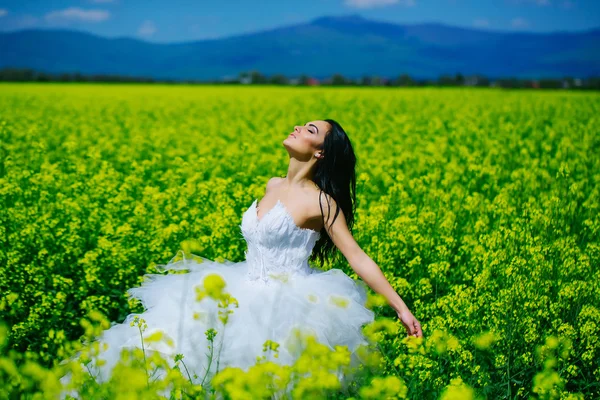 Bonita chica de la boda en flores de campo verde amarillo — Foto de Stock