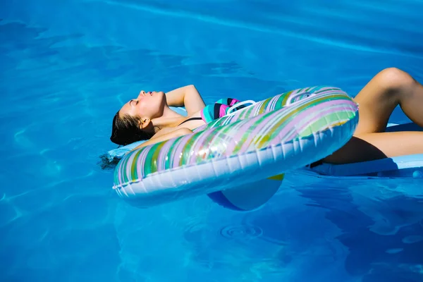 Jong meisje zwemmen met ring — Stockfoto