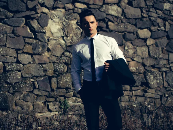 Young man holds suit coat