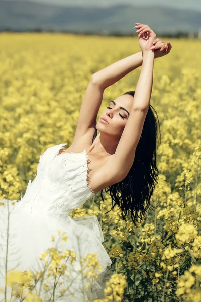Pretty wedding girl in yellow field flowers — Stock Photo, Image