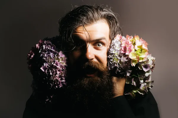 bearded man with hydrangea flowers