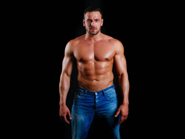 Muscular shirtless fashion male model. Strong man. Guy in vogue style on a black background. Young businessman. Athlete from a beautiful body. Beautiful young mans naked torso. — Stock Photo, Image