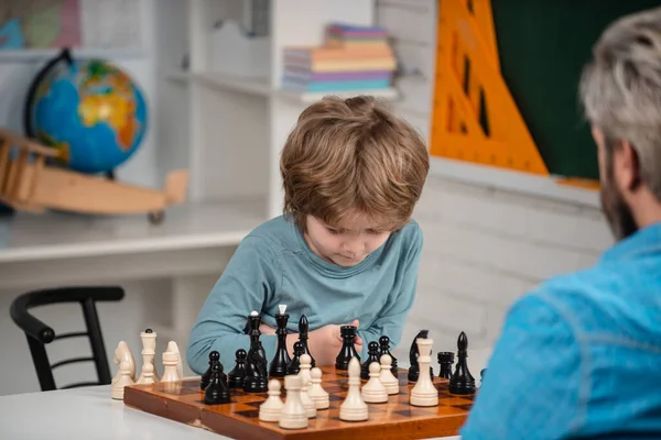 Happy child and childhood. Kid Playing Chess. Intelligent, smart ass kids. Games good for brain intelligence concept. — Photo