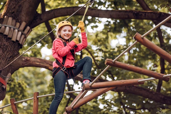 Hike and kids concept. Toddler kindergarten. Eco Resort Activities. Happy child boy calling while climbing high tree and ropes. Children summer activities. — Stock Photo, Image