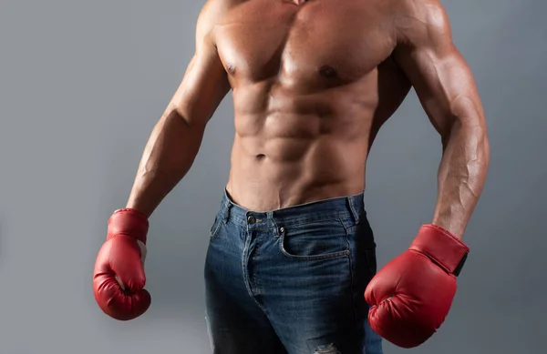Man power. Boxer in fighting gloves. Success guy in red boxing gloves isolated on gray background, sports conflict fight knockout concept. Handsome man with power gesture.