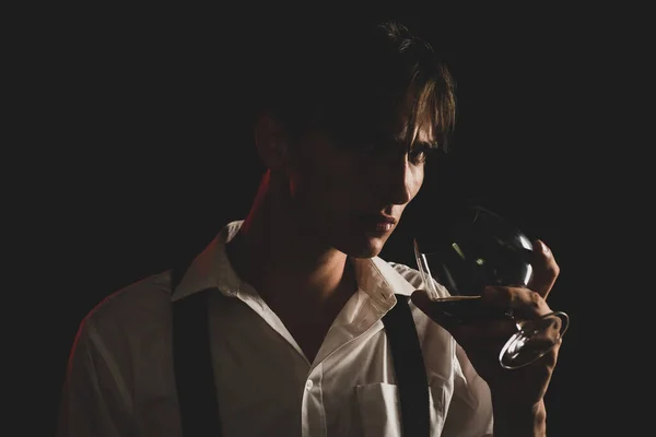 Coñac caro. Degustación y degustación. El hombre sostiene una copa de brandy. Joven hombre de negocios en traje elegante beber whisky. —  Fotos de Stock