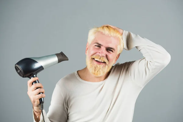 Men blonde hair color with hair dryer. Blow-dry your hair.