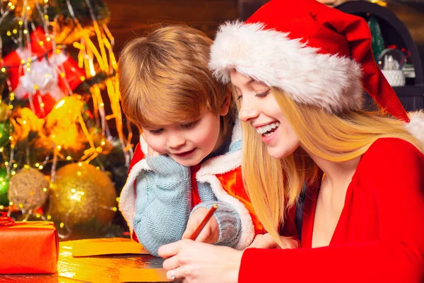 Mom and kid play together christmas eve. Happy family. Family holiday. Santa claus coming. Mother and little child boy adorable friendly family having fun. Family having fun at home christmas tree — Stock Photo, Image