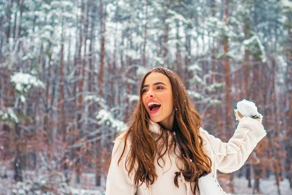 Retrato de invierno de mujer joven. Modelos divirtiéndose en el parque de invierno. Retrato de una hermosa mujer vestida con un abrigo. — Foto de Stock