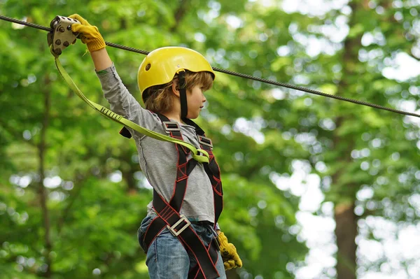 Go Ape Adventure. Adventure climbing high wire park. Child. Happy child boy calling while climbing high tree and ropes. Every childhood matters. Balance beam and rope bridges. — Stock Photo, Image