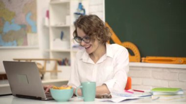 Sınıfta güzel bir öğretmen var. Bir kız öğrencinin portresi. Öğrenme ve eğitim kavramı. Yeşil karatahtanın üstünde gözlüklü genç öğretmen.