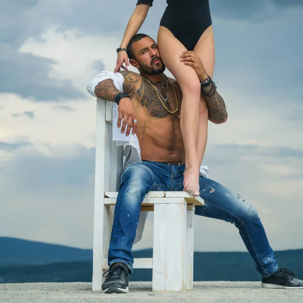 Love and flirt. Muscular man and fit slim young female.Couple goals. Erotica.