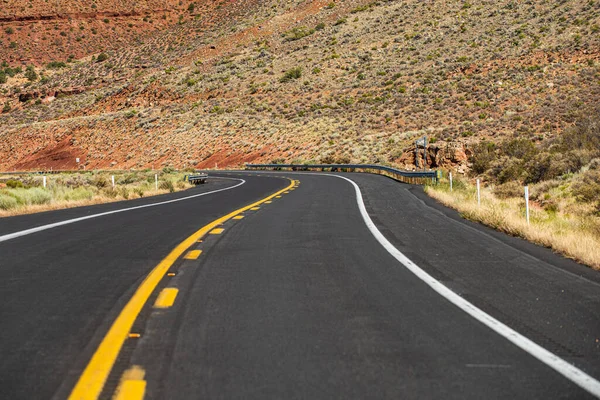 American roadtrip. Landscape with rocks and asphalt road in the evening in summer. — Stock Photo, Image