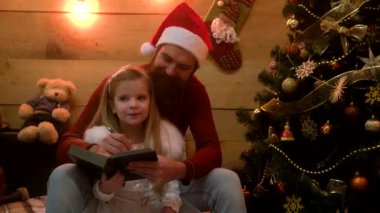 Gülümseyen baba ve kız Noel Baba 'ya bir dilek listesi yazıyorlar. Aile Noel 'i, çocuk mutluluğu ve insanların konsepti.