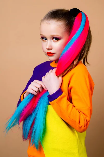 Kids fashion. Colorful child hair. Trendy hairstyle concept. Girl with colorful dyed hair.