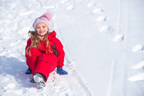 Little girl playing on snow in winter. — Stock Photo, Image