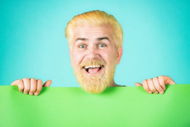 Gülümseyen adam elinde boş kâğıt pano ve metin için fotokopi alanı tutuyor. Elinde kocaman bir tabela tutan adam. Mutlu orta yaşlı adam boş kağıt sunuyor..