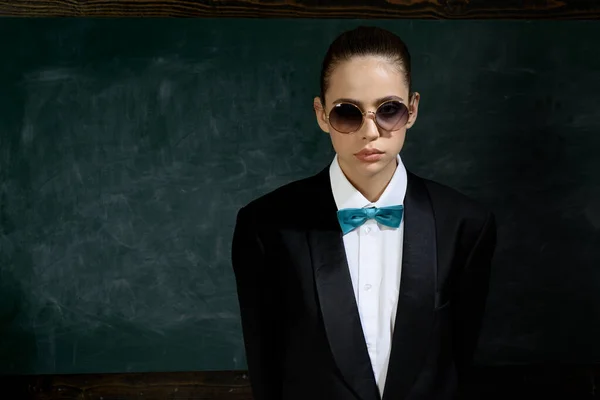 Woman wear masculine clothes tuxedo bow tie and eyeglasses. Sunglasses formal style. Girl formal jacket suit and sunglasses copy space. Fashion trend. Stylish sunglasses accessory. Fashion outfit
