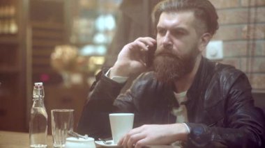 Yakışıklı iş adamı telefonda konuşuyor ve kafede kahve içiyor. Düşünceli genç adam şekerleme dükkanında oturuyor. Birini bekliyor..