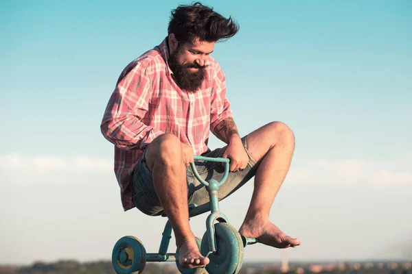 Man acting like a kid. Funny man on a bicycle. Emotional crazy guy on a childrens bike. — Stock Photo, Image