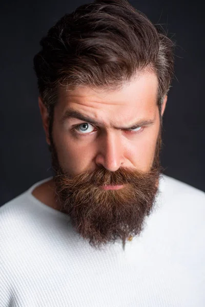 Portrait of stylish handsome young man with beard standing on black wall. — Stock Photo, Image