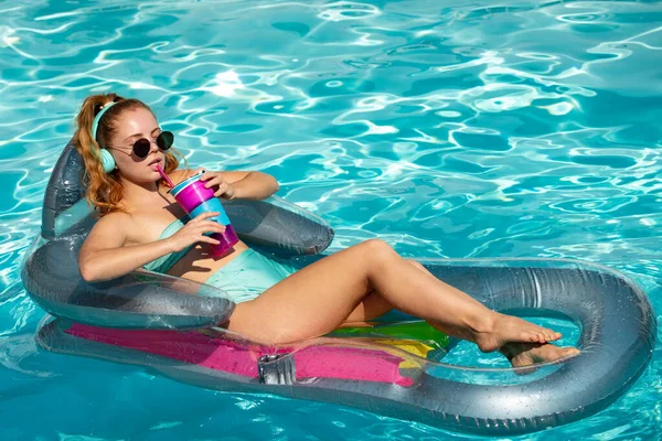 Joyeux jeune femme jouant avec anneau de natation coloré dans la piscine le jour d'été. Des jouets aquatiques. Fille dans une station tropicale. Vacances à la plage. — Photo