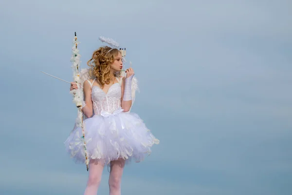 Angel adolescente con flecha y alas. Encantadora niña rizada en vestido blanco y alas niña ángel Cupido. Día de San Valentín. Espacio para el texto. Postal para el Día de San Valentín — Foto de Stock