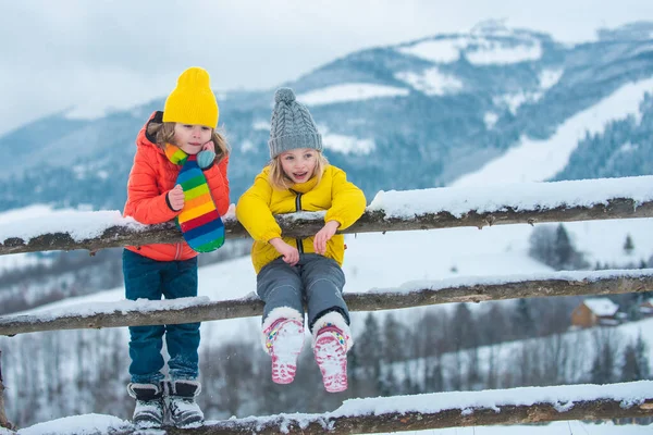 Winter children friends. Kids enjoying nature wintertime. Winter child happy. People in snow. Theme Christmas holidays winter new year.