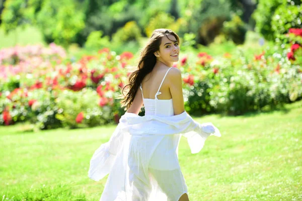 Spring woman in summer fields outdoors walking in field. Woman enjoy outdoor recreation. Natural beauty. Spring time.