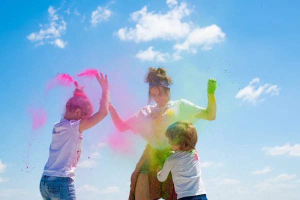 Эмоциональные веселые возбужденные дети с цветным порошком и цветной пылью всплеск. — стоковое фото