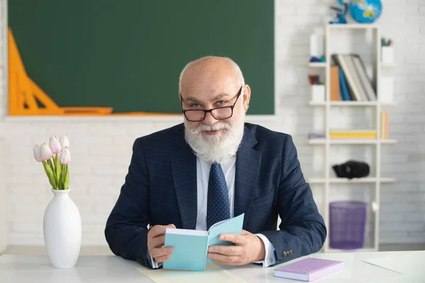 Professeur de cheveux gris dans une salle de classe vide. Professeur d'école ou conférence collégiale et universitaire. — Photo