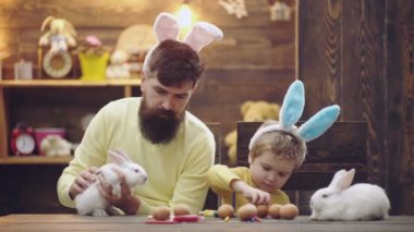 Babası ve çocuğu Paskalya tavşanları. Baba ve tavşan kulaklı çocuk. Aile ilişkileri.