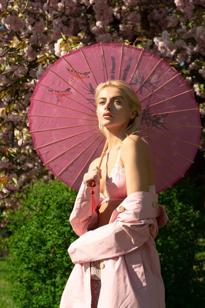 Fashion nature. Beautiful young girl on flowering trees. Spring. Pink dress. Sensual Portrait, Romance. — Stock Photo, Image