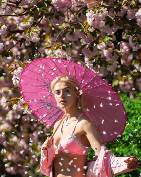 Ritratto di giovane donna sexy. Faccia sorridente di ragazze di primavera. Petali di fiori. — Foto Stock