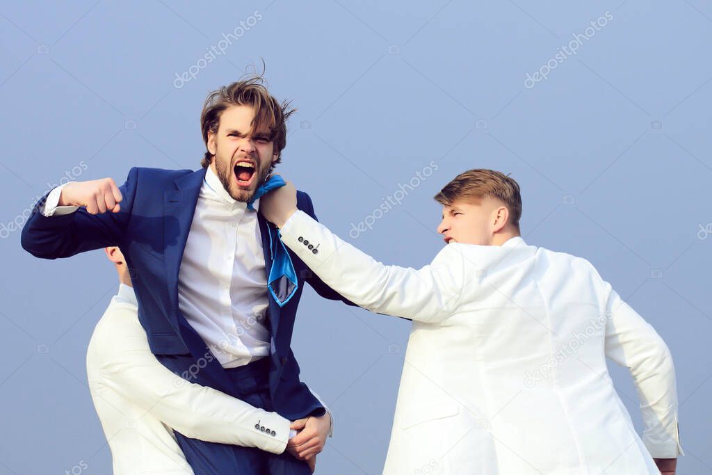 Business man fighting. Group of business people fighting on blue sky background, conflict.