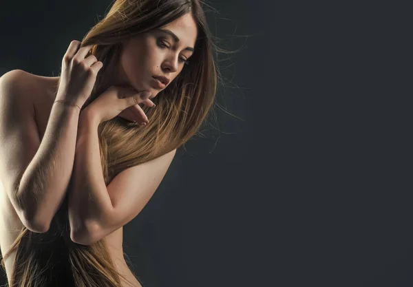 Mujer sexy con cabello largo y saludable y cuerpo desnudo sobre fondo negro, salón de belleza —  Fotos de Stock