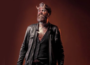 Şeytan boynuzlu Şeytan Adam. Kırmızı kanlı şeytan kahverengi arka planda.