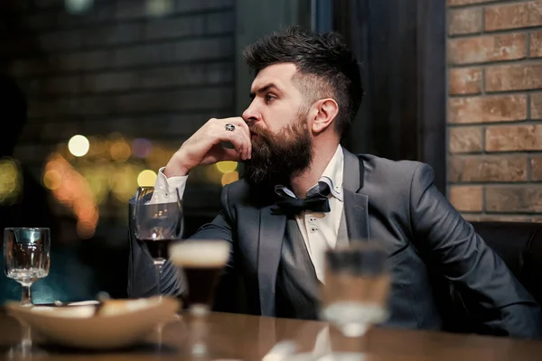 Bad dating. Confident man sitting at bar alone.