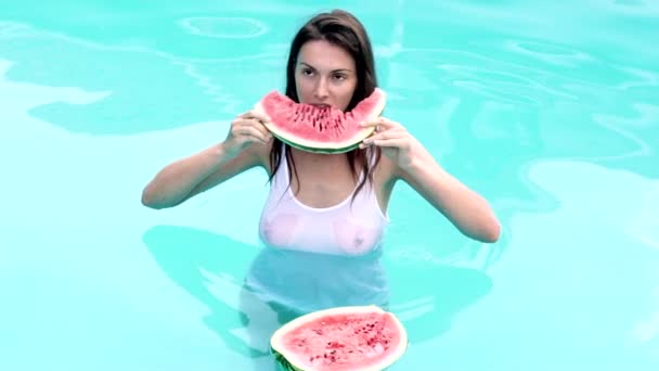 Sommer sexy Frau essen Wassermelone im Pool. Gesundes Ernährungskonzept, Obst der Saison, Sommerfest, Snacks. Wassermelonenfrüchte. — Stockvideo