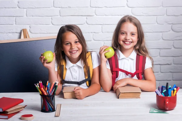 Little girls in classroom at knowledge day. School time of girls. Happy school kids at lesson. Back to school and home schooling. — Stock Photo, Image