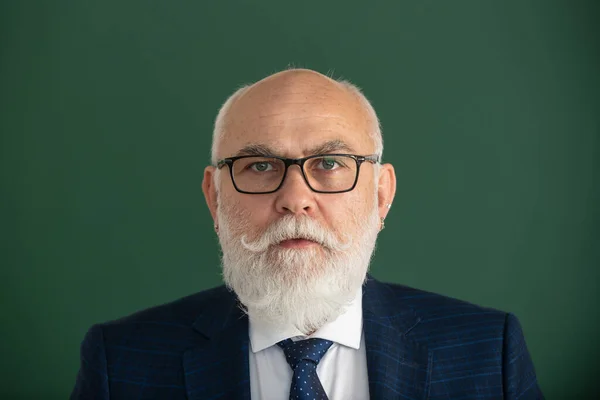 Closeup portrait of old male professor. Portrait of man with copy space. Successful face of mature teacher with eyeglasses.