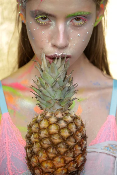 Summer makeup. Pineapple fruit. Fashion girl with colorful powder make up. Abstract colourful make-up.