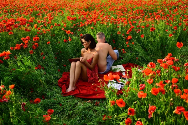 Spring couple on poppy field. Naked nature. Lovers in flowers lawn. Sensual seductive. Love story. Erotica love game.