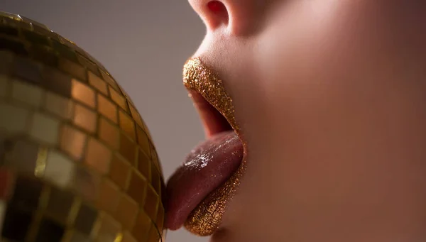 Sensual golden lips. Fashion gold metal lip. Beautiful make-up.