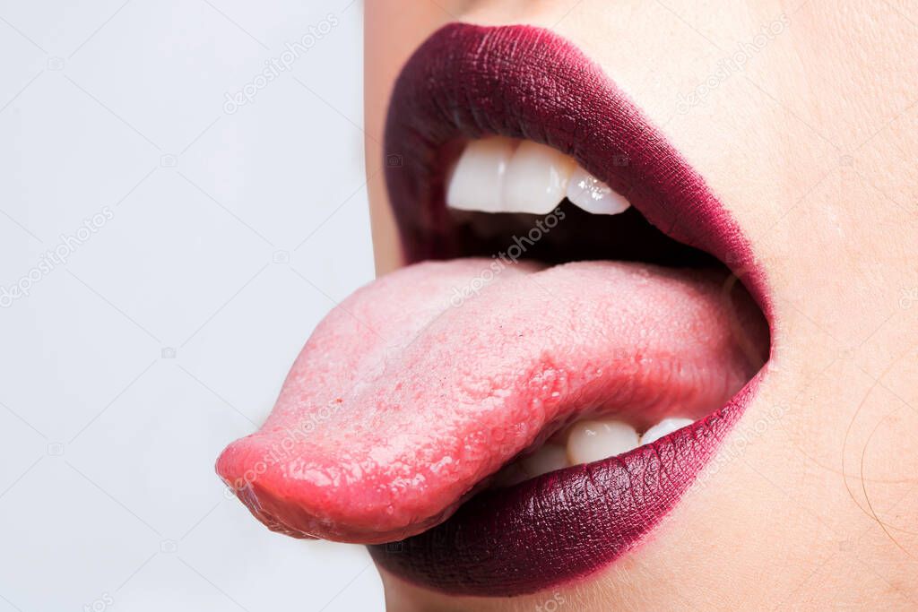 Female open mouth with sexy lips purple lipstick and tongue