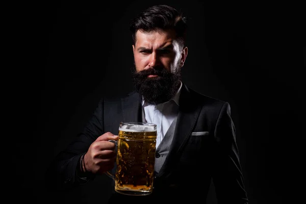 Portrait of serious bearded man drinking beer. Happy brewer holding glass with beer. — Stock Photo, Image