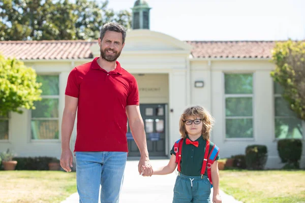 American father and son walking trough school park. — Stock Photo, Image