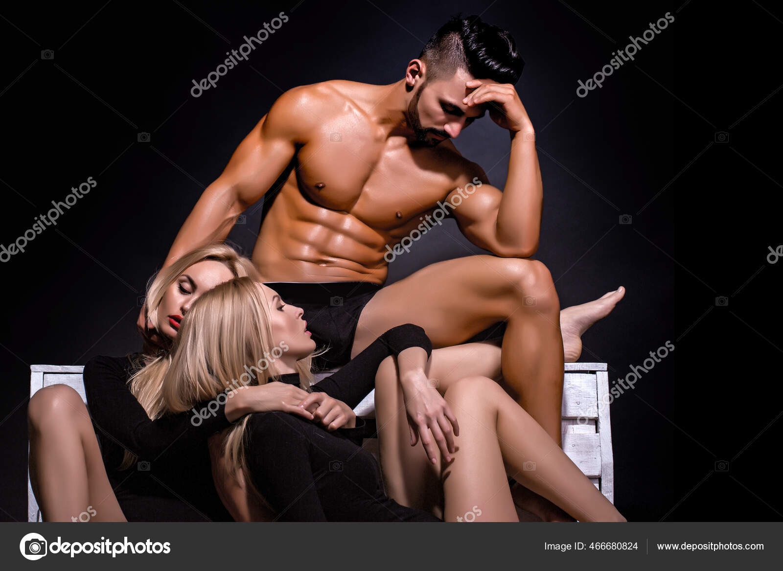 Romance and love, muscular athletic man or macho with naked torso with pretty girl and sexy woman on black. Threesomes lovers photo