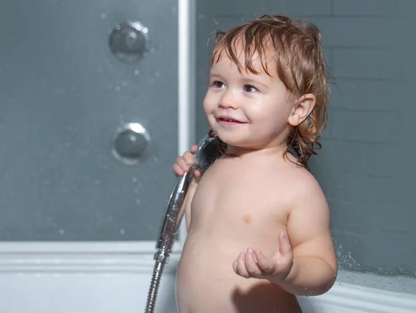 Leuk kind dat in bad speelt. Grappige vrolijke baby baadt in bad met water en schuim. Kinderhygiëne. — Stockfoto